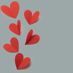 Red paper hearts on gray background concept of Valentine's day