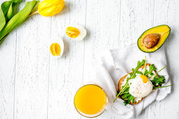 sandwich with poached eggs on wooden background top view mockup