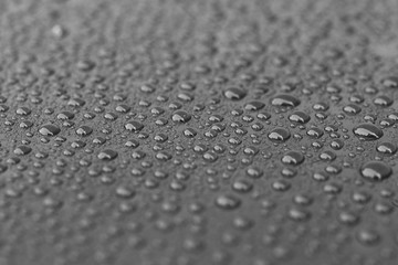 Water drops on dark reflective surface - 245332727