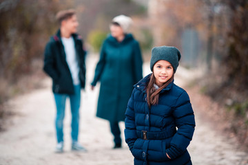 Grandmother and children walk in park.