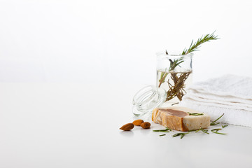Handmade soap on a white background. Skin care with almond and rosemary aroma. Spa treatments and...