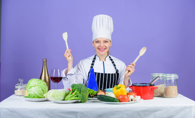Delicious recipe concept. Gourmet main dish recipes. Cooking is her hobby. Cooking healthy food. Girl in hat and apron. Woman chef cooking healthy food. Fresh vegetables ingredients for cooking meal