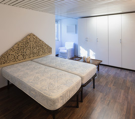 Bedroom with mattress and parquet