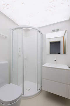 Minimal white bathroom with sink and shower