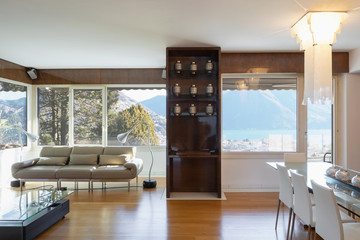Living room with lacquered wood furniture and lake view window