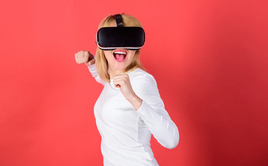 Portrait of young woman wearing VR goggles, experiencing virtual reality using 3d headset. Person with virtual reality helmet isolated on red background. VR poster.