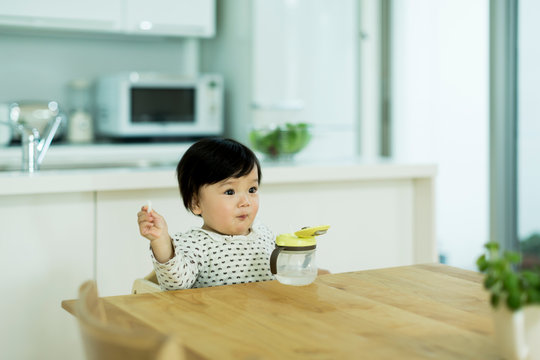 Girl eating food at table
