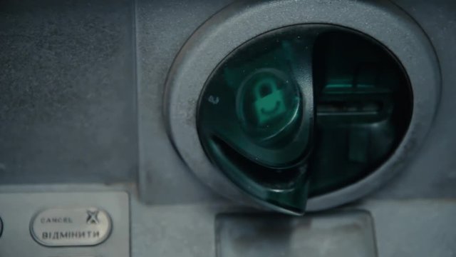 Blinking grunge slot in ATM machine. Withdrawal cash. ATM machine is blinking and ready to accept credit card. Green plastic insert to protect bank from hacker to sniff valuable data with shimming
