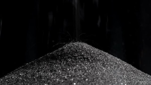 Close-up sands move through hour glass.