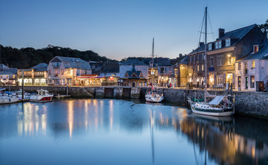 Blue Hour over Padstow Harbour, with reflections of boats and lights - obrazy, fototapety, plakaty