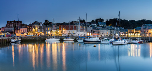 Fototapeta na wymiar Padstow Harbour at Twilight, with reflections of lights and boats