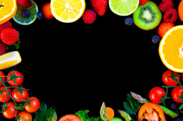 circular background with spring and summer colorful fruits and vegetables on black table from above  with large copy space