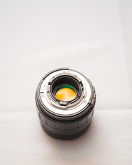 Photo lens from a SLR camera with beautiful colored glare on lenses on a bright background