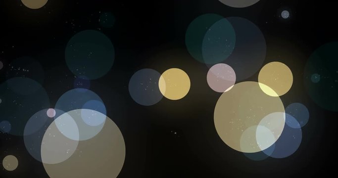 Abstract background with soft circle bokeh defocused and blurred on black background. Blue and yellow and shiny bubbles animated in group floating