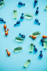 Capsule background with Omega 3, hyaluronic acid and coenzyme. Caring for the health of the skin and body.