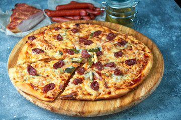 Slice of hot pizza large cheese lunch or dinner crust seafood meat topping sauce. with bell pepper vegetables delicious tasty fast food italian traditional on wooden board table classic in view