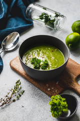 Vegan Creamy Spinach Soup on a grey background