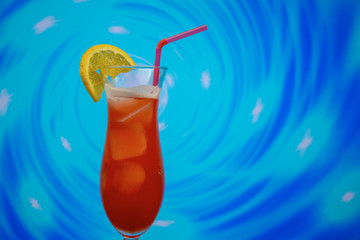 Zombie cocktail in hurricane glass with a straw and slice of lemon