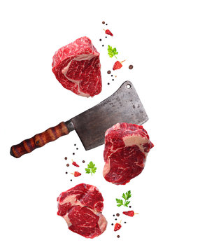 Raw marbled ribeye steak and butchers knife isolated