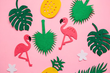 Summer background with a lot of flamingos, tropical leaves and pineapples.