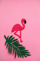 Flamingo and fern leaf on a pink background in minimal style. Summer minimal design.