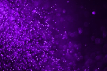 purple lots of flying multi colored light bokeh texture - fantastic abstract photo background