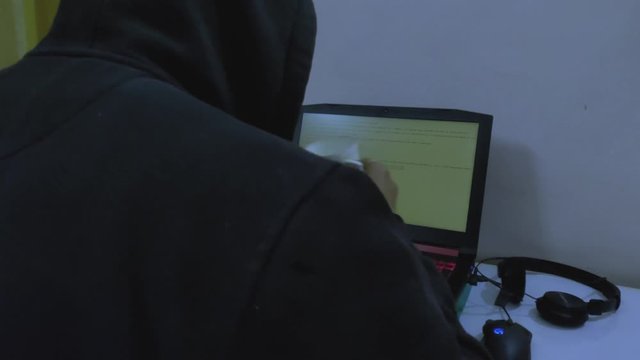 A hacker/person/student typing and coding at night