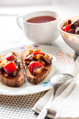 Vegetable stew with eggplant, red pepper and tomatoes on toasted rye bread
