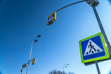 street lighting, supports for ceilings with led lamps. concept of modernization and maintenance of lamps, place for text, day, road sign. crosswalk. a solar panel