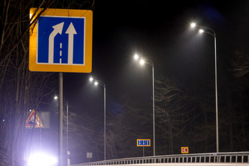 road narrowing sign, street lighting, supports for ceilings with led lamps. concept of...