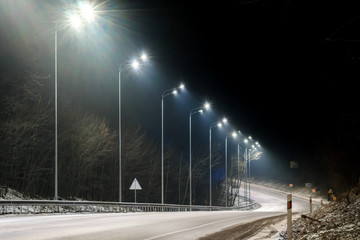 street lighting, supports for ceilings with led lamps. concept of modernization and maintenance of lamps, place for text, night. winter season. energy-saving lamps, safety of movement