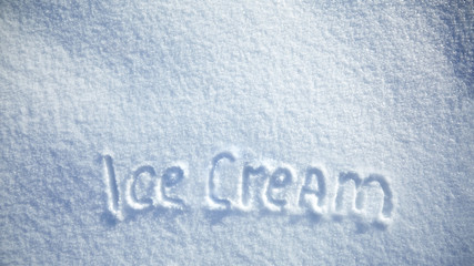 inscription ice cream on snowy background, text on snow surface with copy space, top view