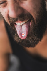 LSD stamp on man's tongue