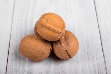 whole walnuts on wooden background, healthy brain food, walnut on light vintage table