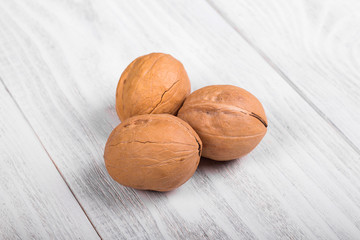 whole walnuts on wooden background, healthy brain food, walnut on light vintage table
