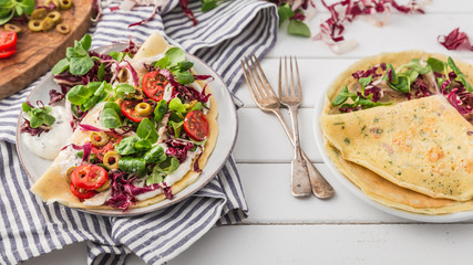hearty pancakes with fresh salad, tomato and radicchio