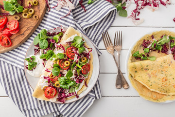 hearty pancakes with fresh salad, tomato and radicchio