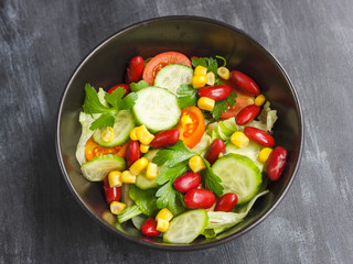 Vegetarian salad with red mexican beans, corn, arugula, cherry tomatoes and olive oil