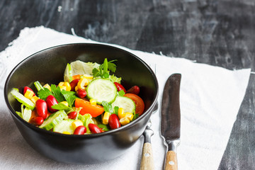 Vegetarian salad with red mexican beans, corn, arugula, cherry tomatoes and olive oil