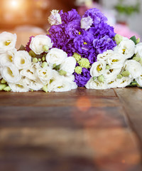 Purple and white flowers on wooden surface