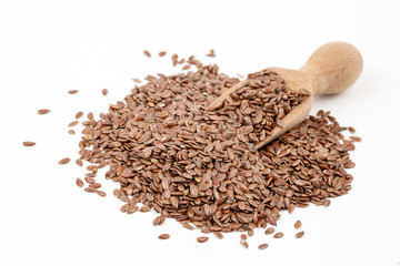 Linum usitatissimum is scientific name of Brown Flax seed. Also known as Linseed, Flaxseed and Common Flax. Pile of grains, isolated white background.