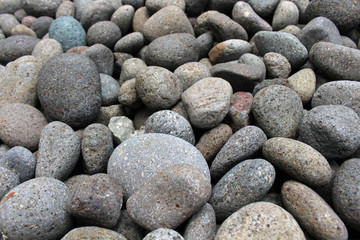 A close up view on pebbles and stones as natural decoration in the garden.
