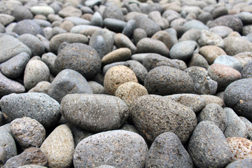 A close up view on pebbles and stones as natural decoration in the garden.