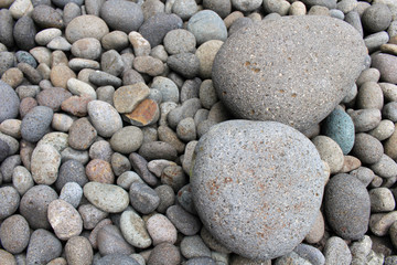 Big stones among smaller pebbles, in the garden.