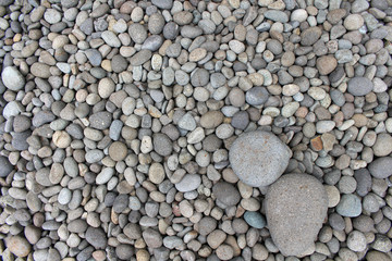 Big stones among smaller pebbles, in the garden.
