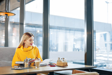 Beautiful blonde-haired student getting ready for exam