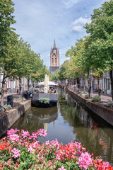 Fototapeta na wymiar The Oude Delft canal in Delft with the Oude Kerk tower in the background.