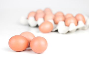 Close up of a group of eggs with box of eggs in the background