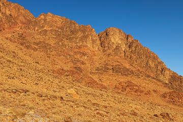 Fototapeta premium Picturesque landscape of rocky mountain peaks in winter morning. Sinai Mountain (Mount Horeb, Gabal Musa, Moses Mount). Sinai Peninsula of Egypt. Pilgrimage place and famous touristic destination