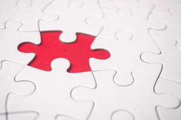 Fototapeta premium the last piece of jigsaw puzzle missing on red background to complete the mission